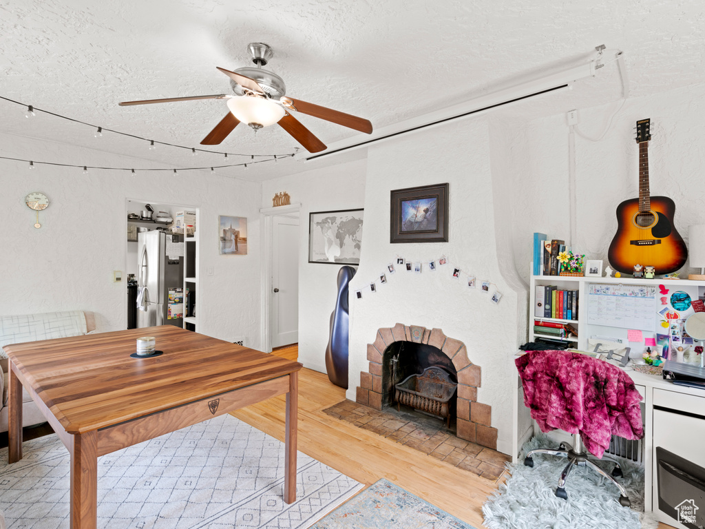 Office space featuring light hardwood / wood-style floors, a textured ceiling, and ceiling fan