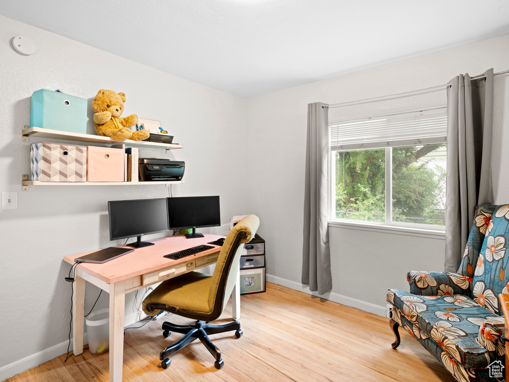 Office area with light wood-type flooring