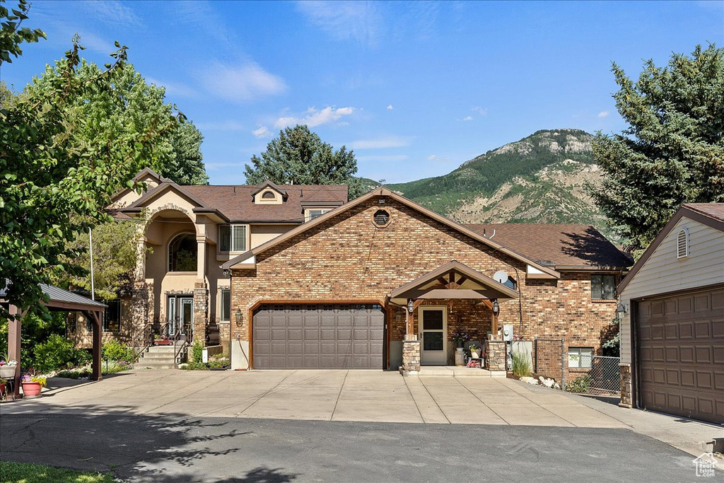 View of front facade featuring a garage and a mountain view