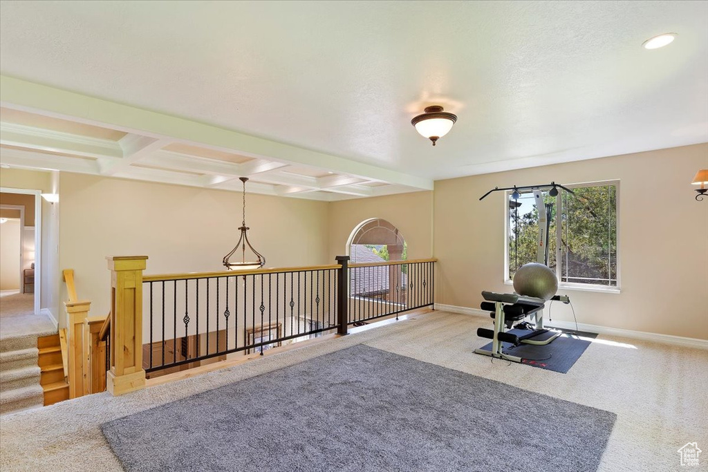 Interior space featuring carpet flooring and coffered ceiling