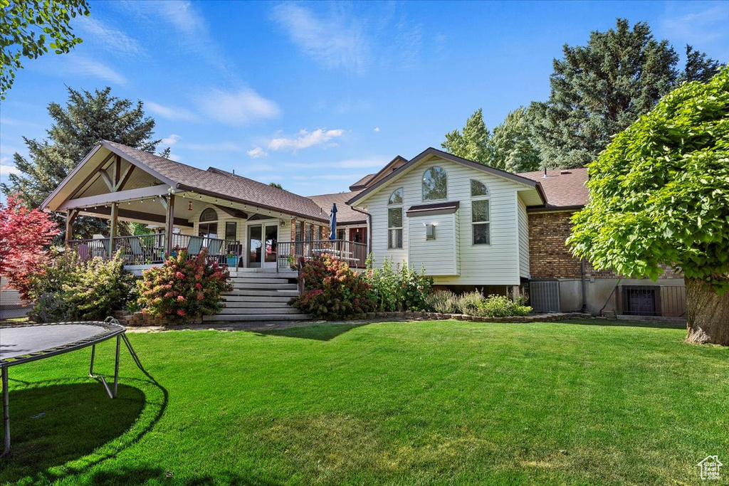 Rear view of property featuring a lawn