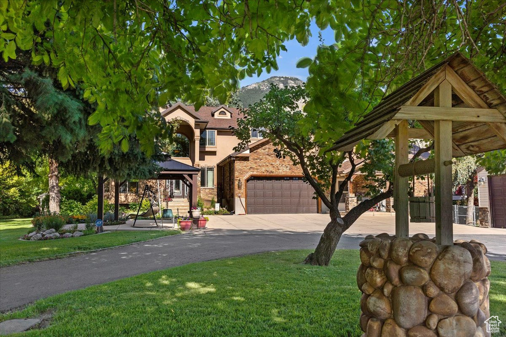 View of front of property featuring a front yard and a gazebo