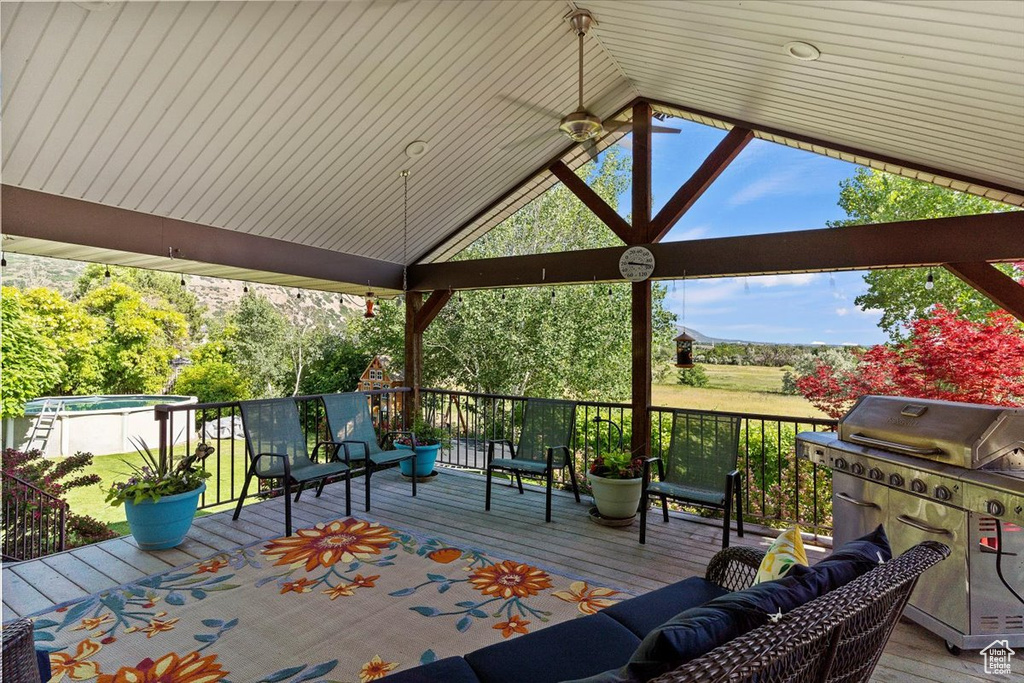 Wooden deck featuring outdoor lounge area, a swimming pool, and area for grilling