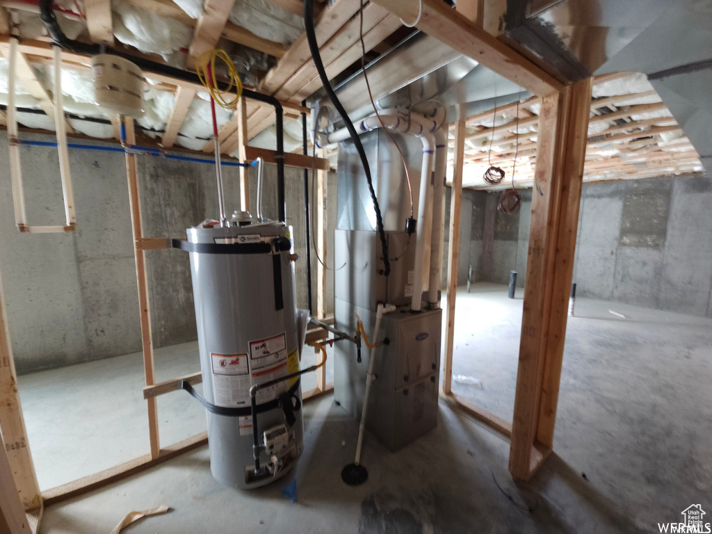 Utility room with heating utilities and strapped water heater