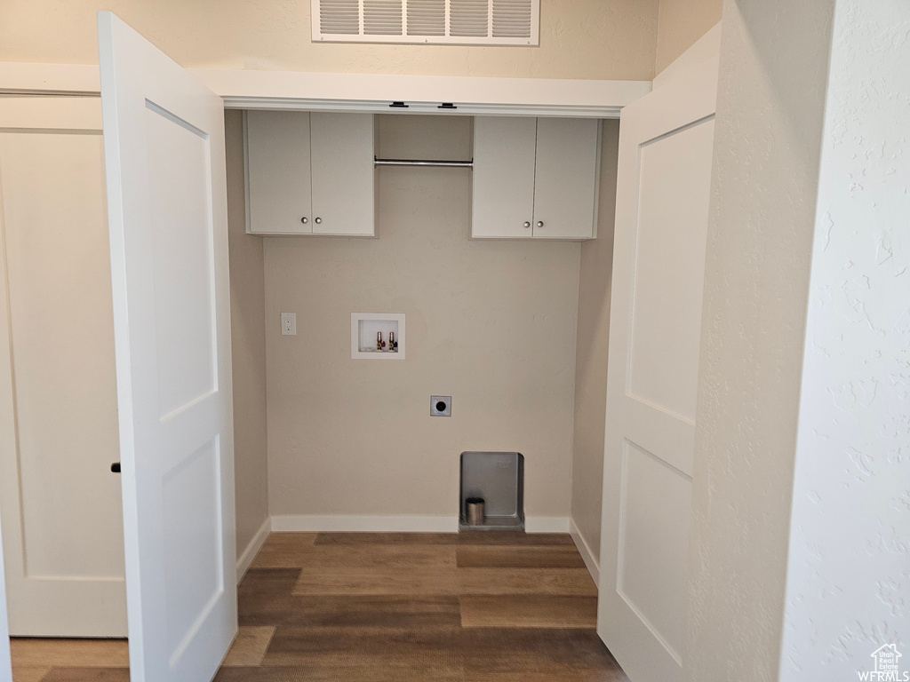 Laundry area featuring cabinets, washer hookup, hardwood / wood-style flooring, and hookup for an electric dryer