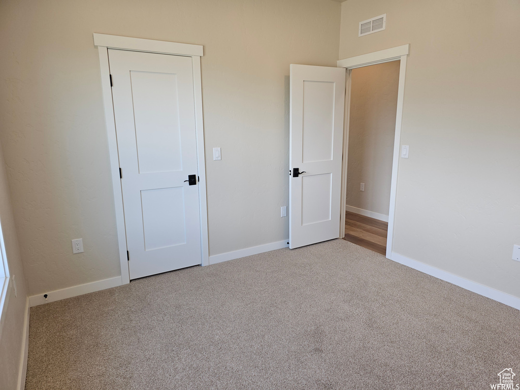 Unfurnished bedroom featuring carpet