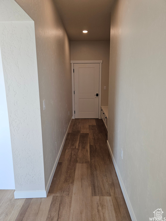 Hall with hardwood / wood-style flooring