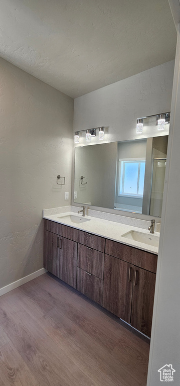 Bathroom with double sink vanity and hardwood / wood-style floors