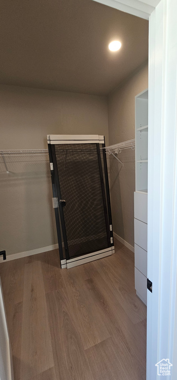 Walk in closet featuring hardwood / wood-style flooring