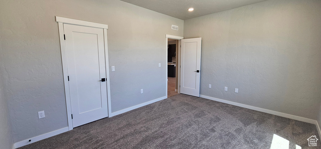 Unfurnished bedroom with carpet flooring