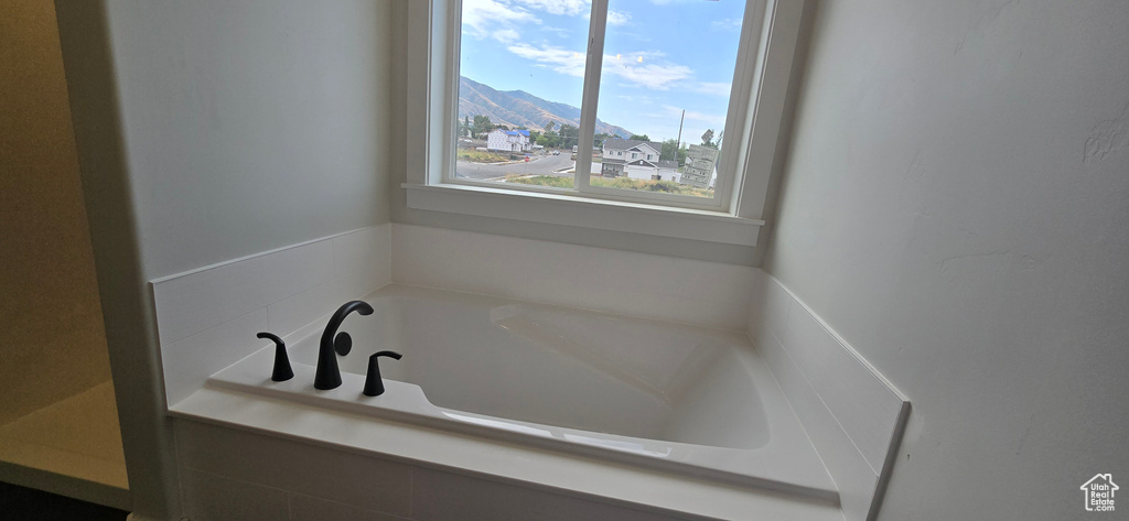 Bathroom featuring a bathing tub and a mountain view