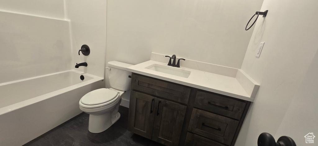 Full bathroom with tile patterned floors, vanity, washtub / shower combination, and toilet