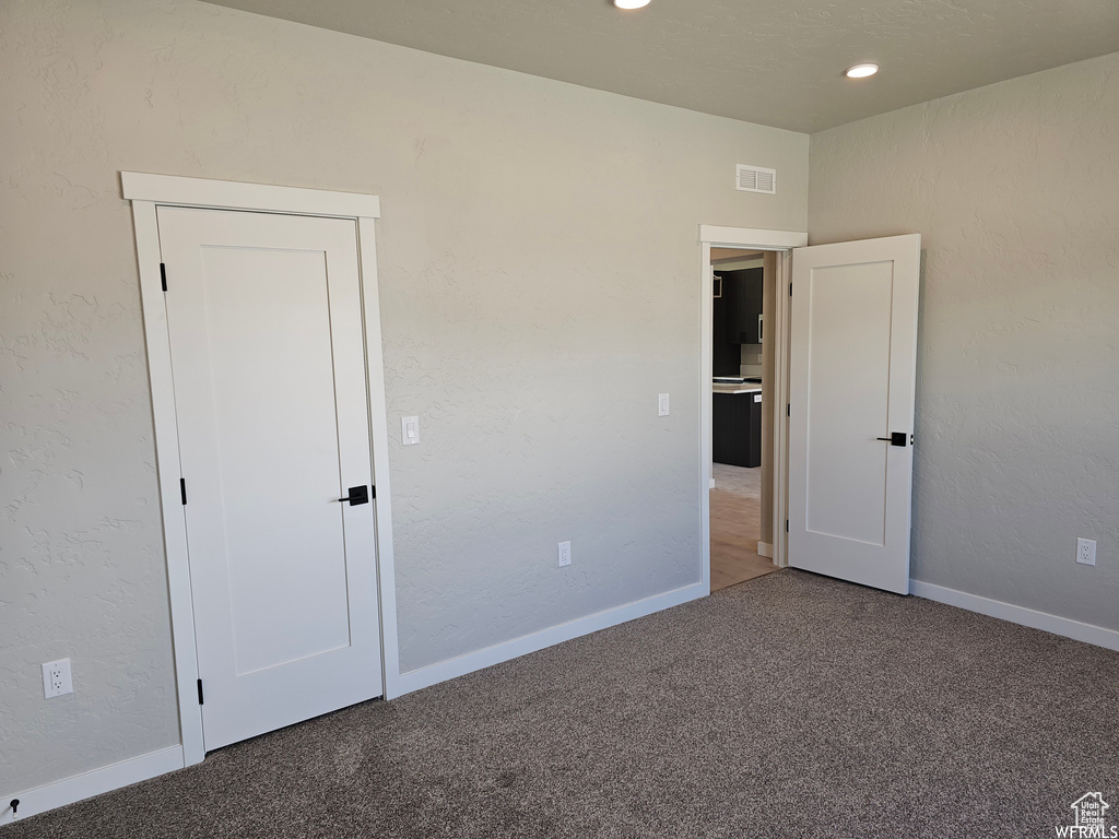 Unfurnished bedroom with carpet