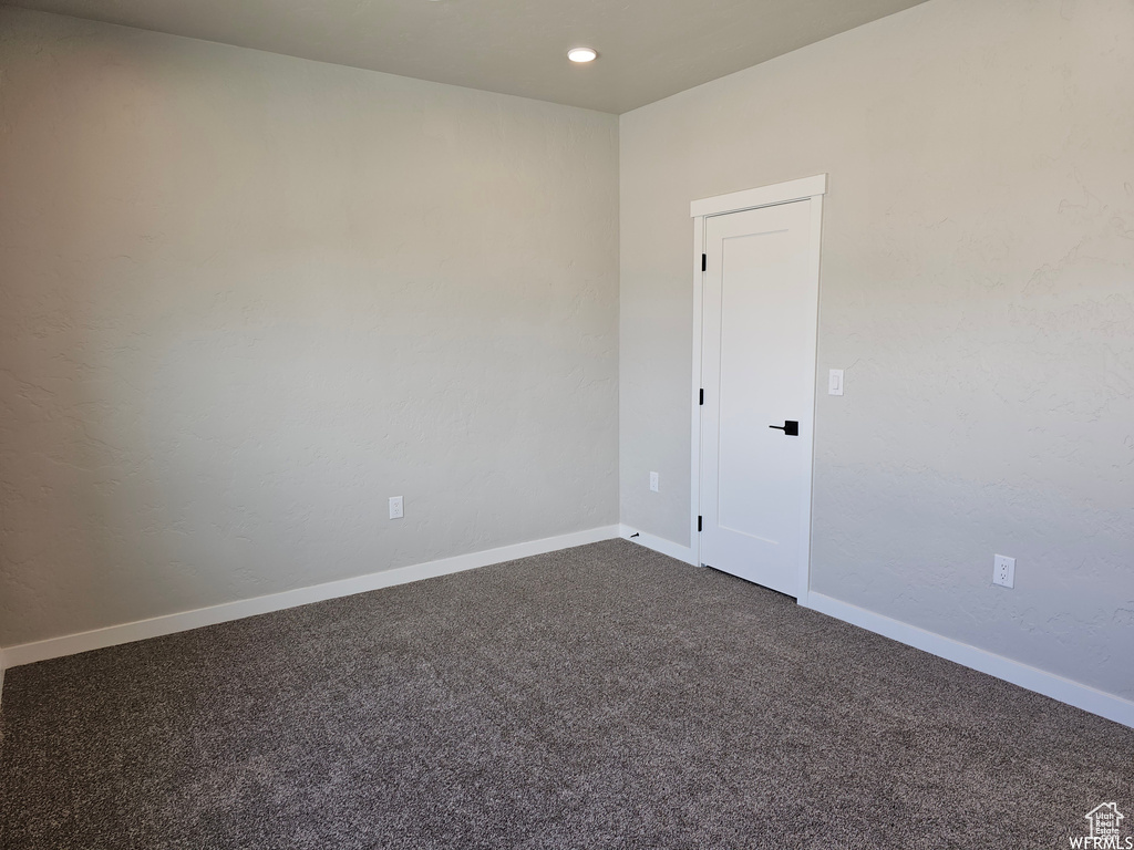 Unfurnished room with carpet