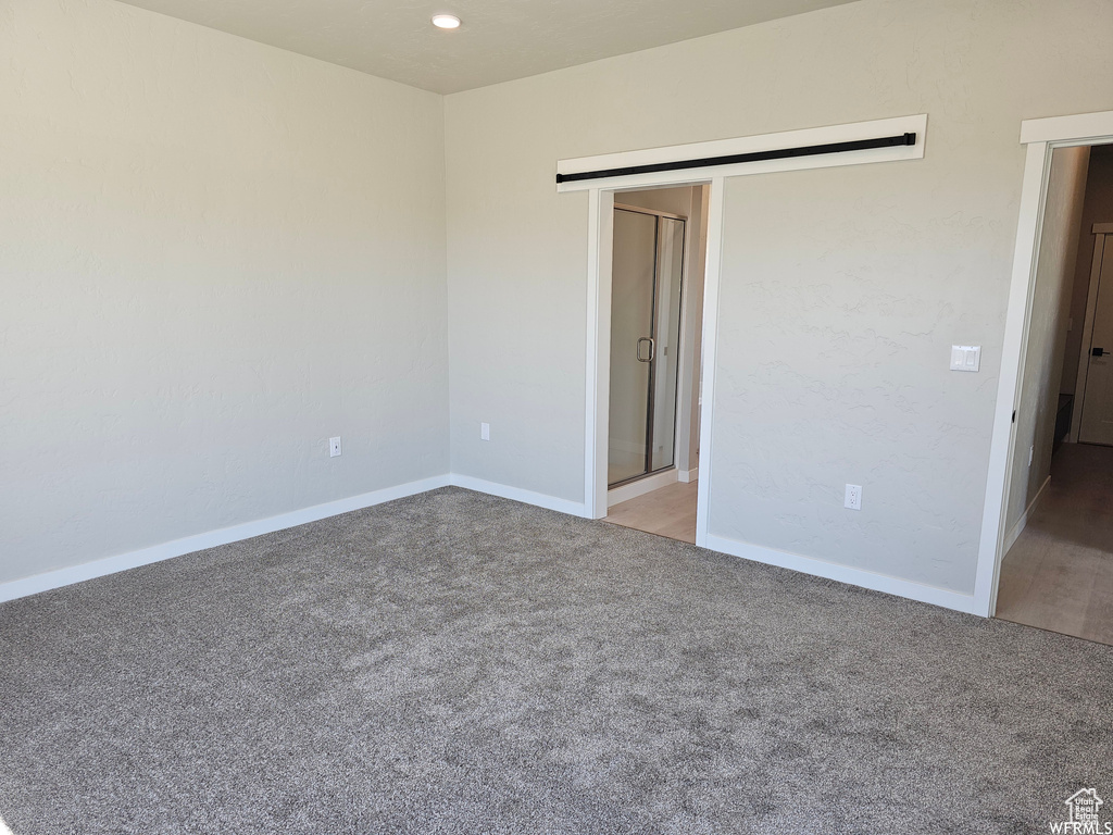 Unfurnished bedroom with carpet flooring