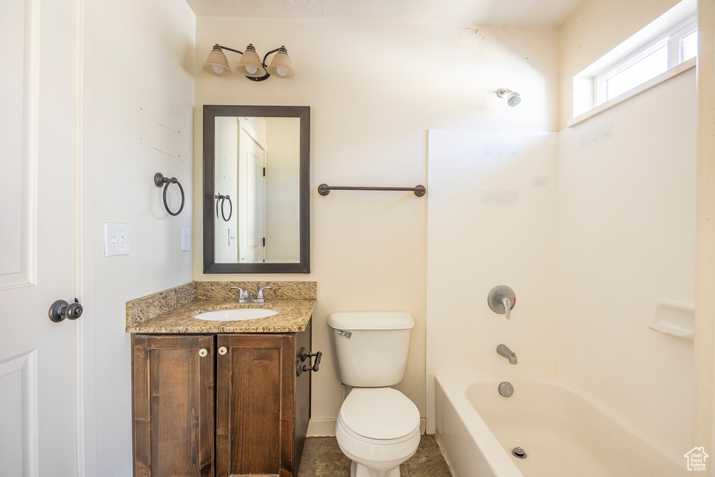 Full bathroom featuring tile flooring, washtub / shower combination, toilet, and vanity