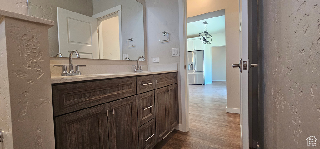 Bathroom with hardwood / wood-style flooring and double sink vanity