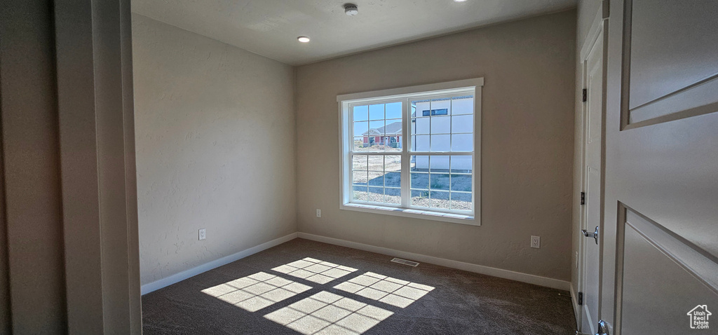 Empty room with carpet floors