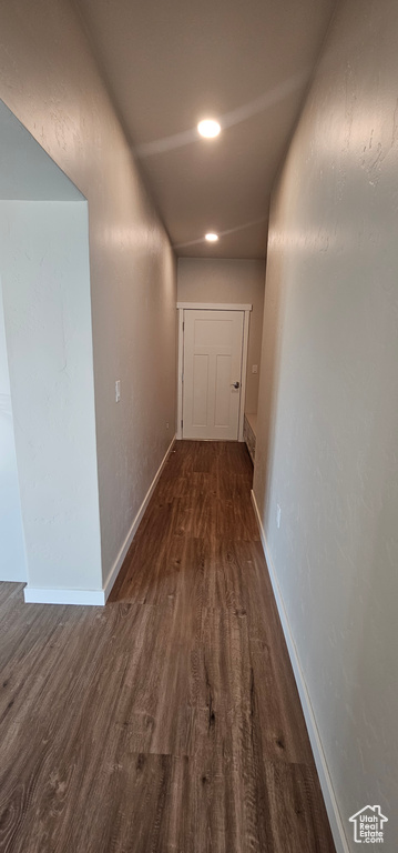 Corridor with dark hardwood / wood-style flooring