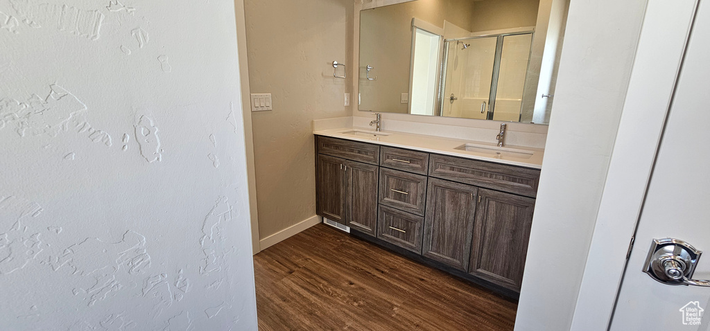 Bathroom featuring hardwood / wood-style flooring and dual bowl vanity