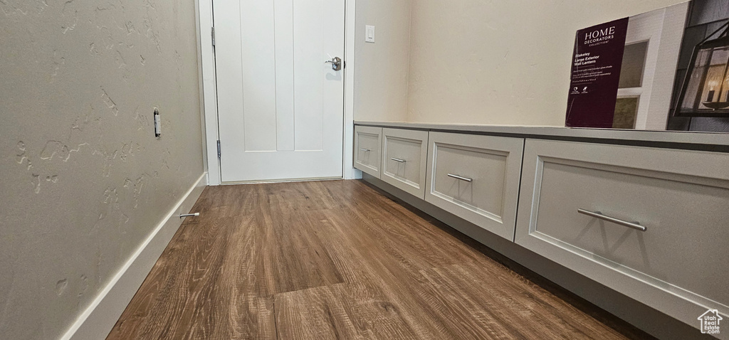 Hallway with dark hardwood / wood-style floors