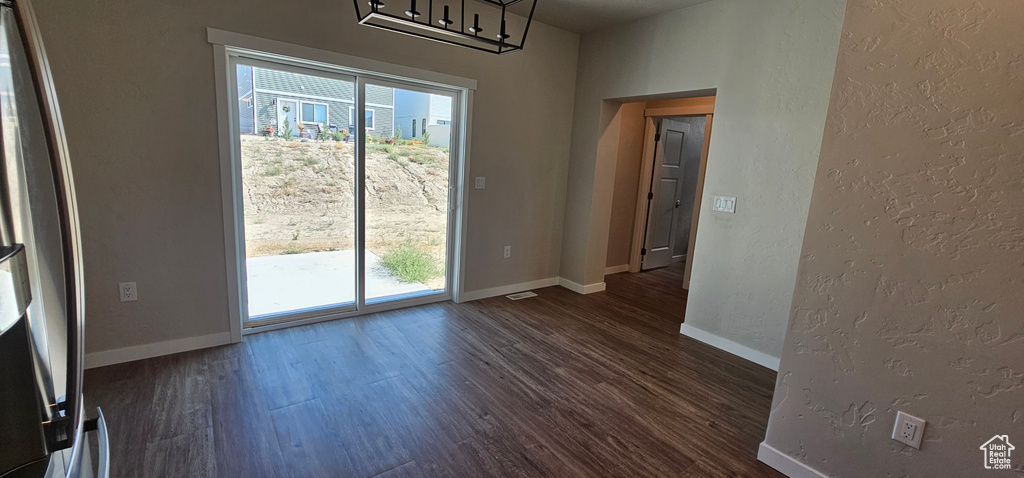 Interior space with dark hardwood / wood-style floors