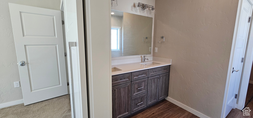 Bathroom featuring hardwood / wood-style flooring and double sink vanity