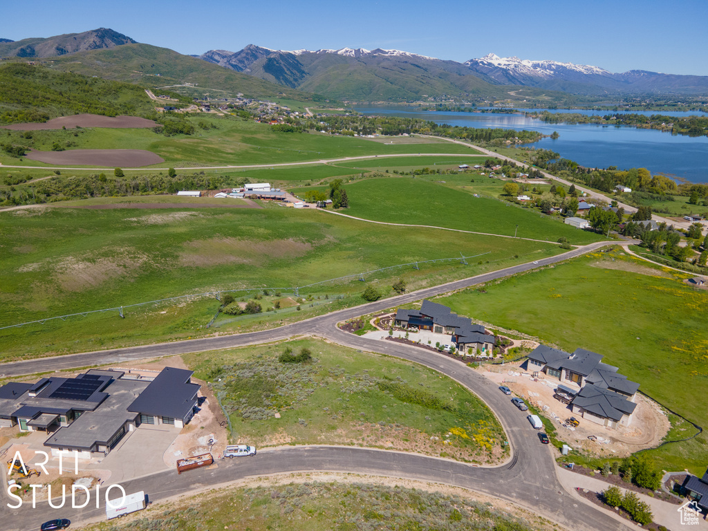 Birds eye view of property featuring a water and mountain view