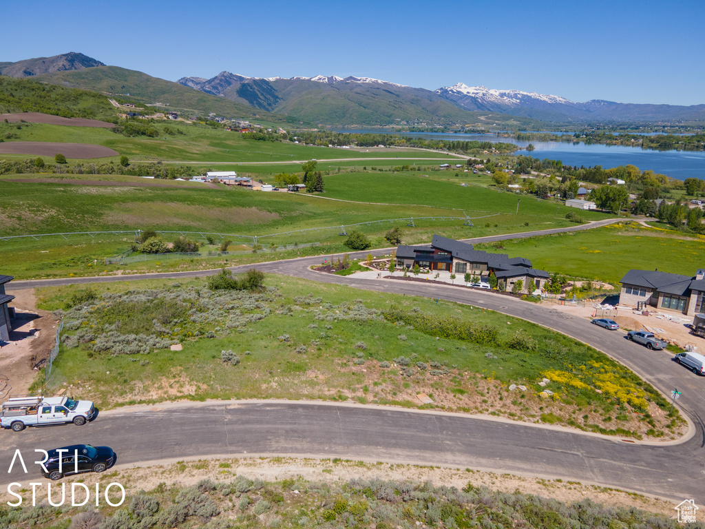 Birds eye view of property featuring a water and mountain view