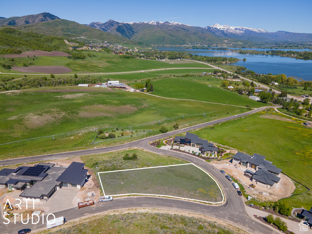 Birds eye view of property featuring a water and mountain view