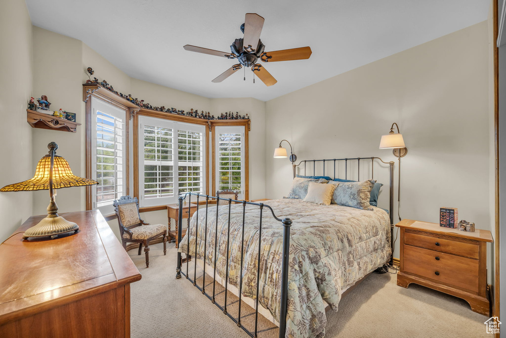 Carpeted bedroom with ceiling fan