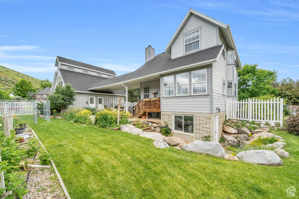 Back of house featuring a yard
