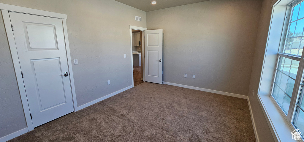 Spare room featuring carpet