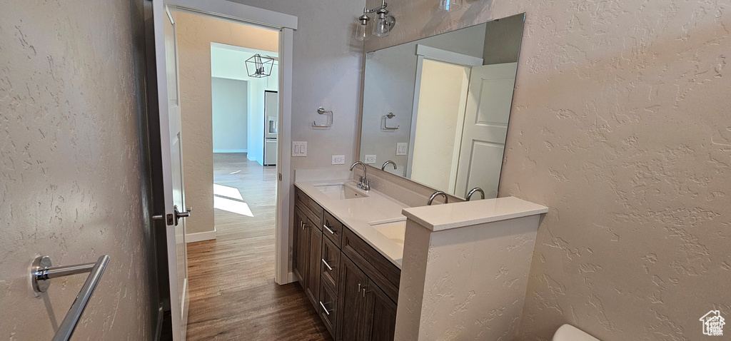 Bathroom with dual sinks, hardwood / wood-style floors, and oversized vanity