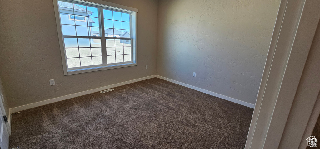 Spare room featuring carpet