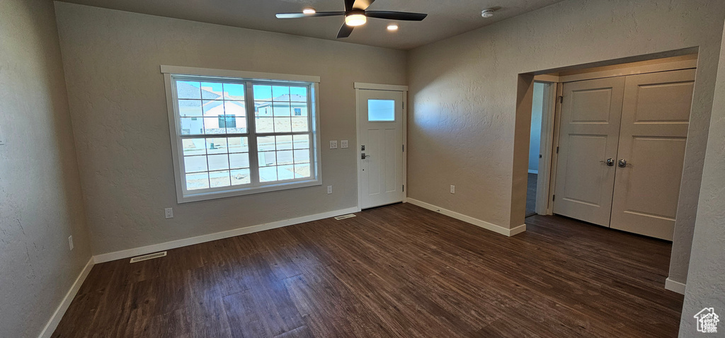 Foyer featuring dark hardwood / wood-style flooring, ceiling fan, and plenty of natural light