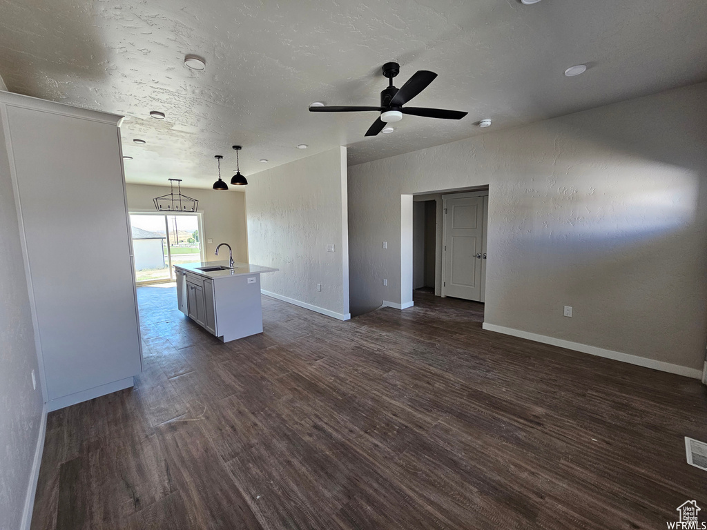 Interior space with sink, ceiling fan, and dark hardwood / wood-style flooring