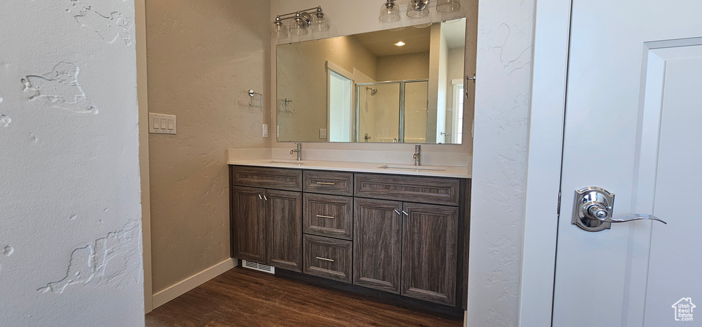 Bathroom with double sink vanity and hardwood / wood-style floors