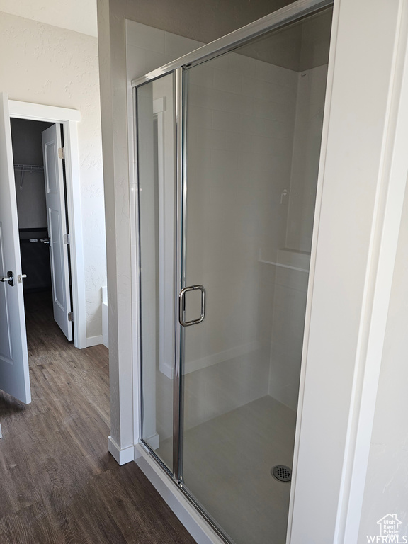 Bathroom with wood-type flooring and an enclosed shower