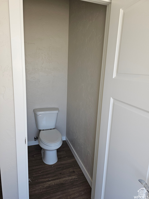 Bathroom with hardwood / wood-style floors and toilet