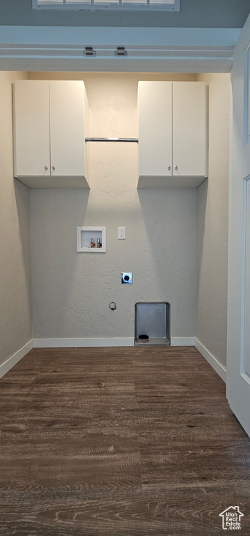 Clothes washing area with electric dryer hookup, hookup for a gas dryer, cabinets, and hardwood / wood-style floors