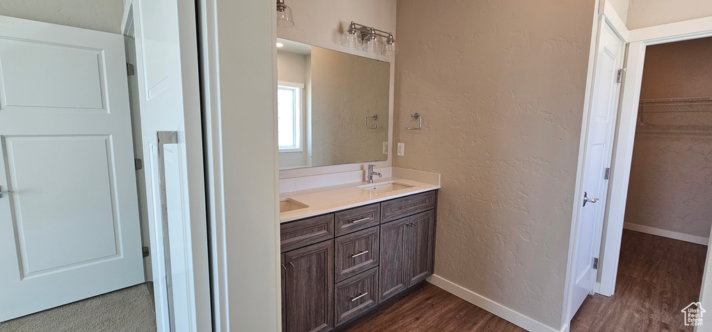 Bathroom with vanity and hardwood / wood-style flooring