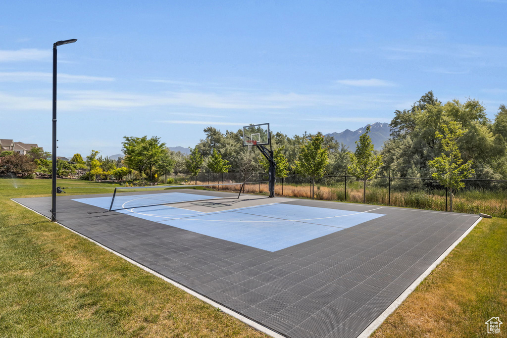 View of basketball court with a lawn