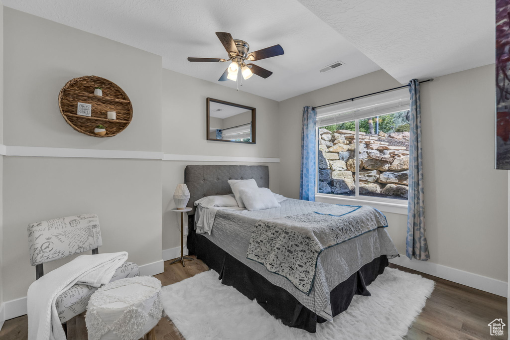 Bedroom featuring hardwood / wood-style floors and ceiling fan