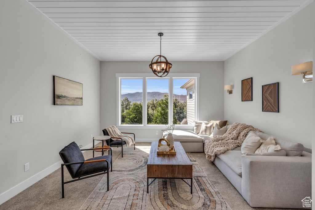 Living room with carpet flooring and an inviting chandelier