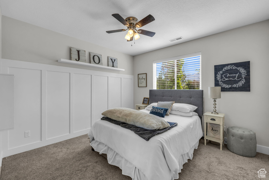 Bedroom featuring ceiling fan and carpet floors