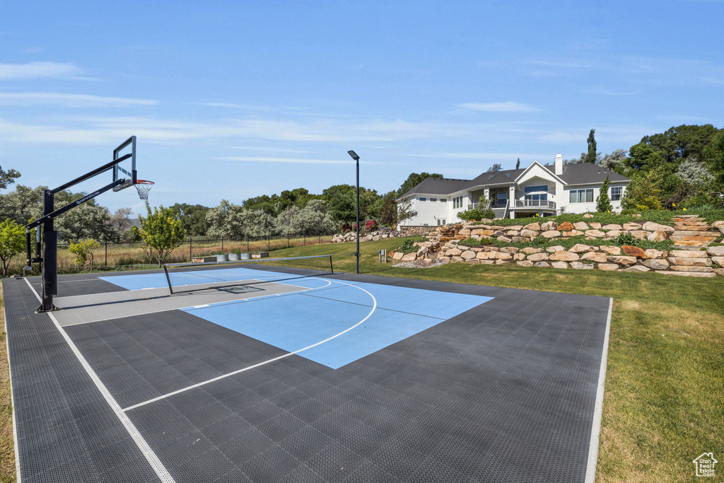 View of basketball court with a lawn