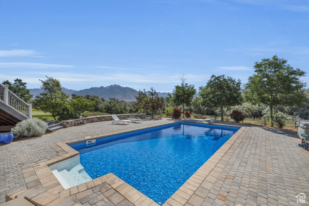 View of pool featuring a patio and a mountain view