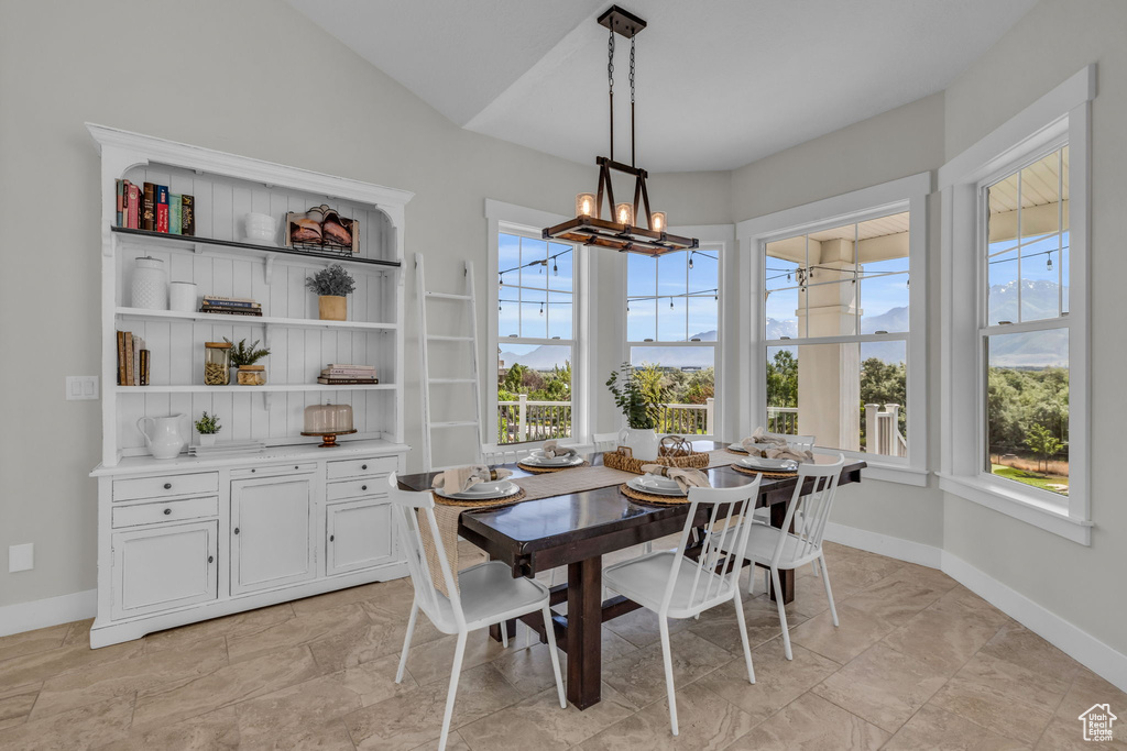 Dining space featuring an inviting chandelier and light tile flooring