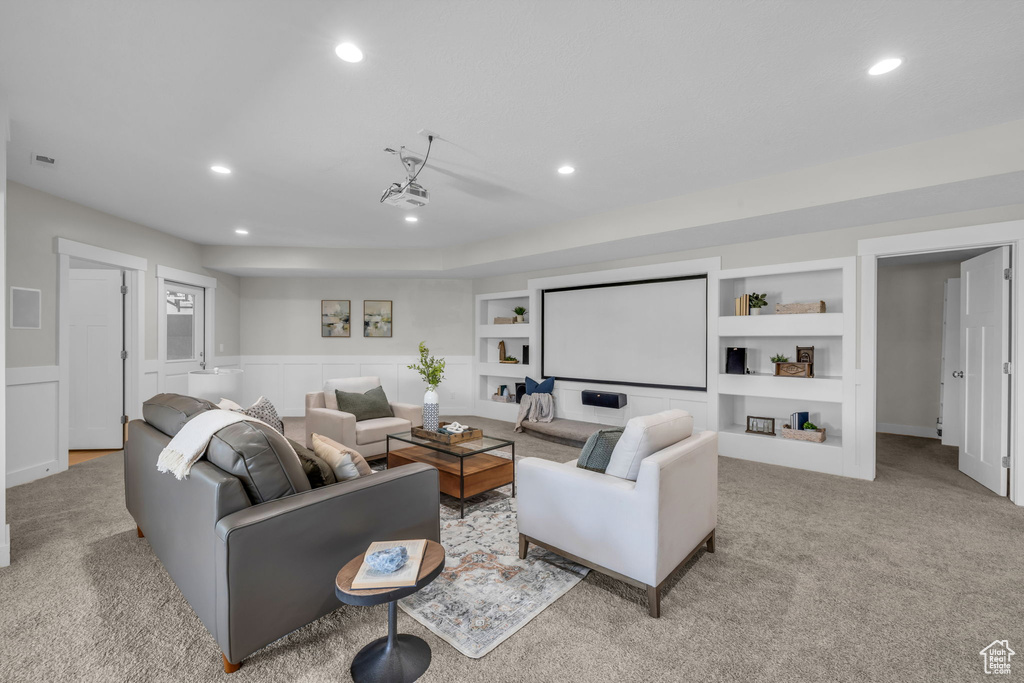 Carpeted living room with built in shelves